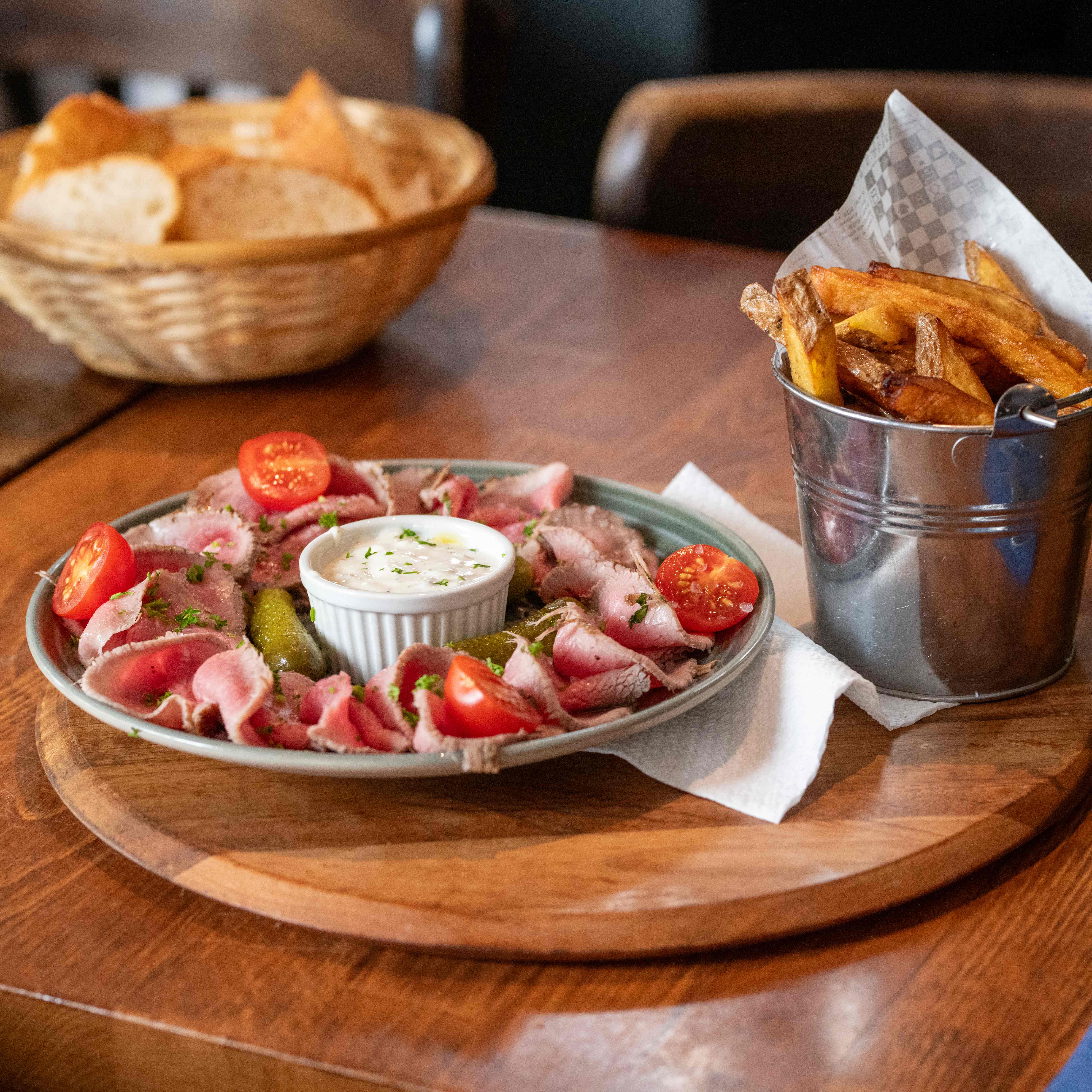 Delicious meat platter with fries and accompaniments
